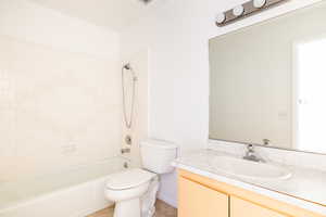 Full bathroom featuring vanity, toilet, tile patterned floors, and tiled shower / bath