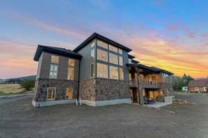 Back house at dusk with a balcony