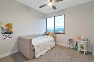 Carpeted bedroom featuring lofted ceiling and ceiling fan