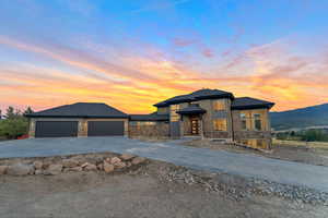 Prairie-style home featuring a garage and a mountain view