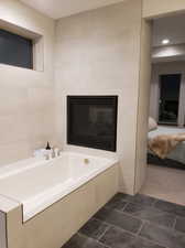 Bathroom featuring tile walls and a bathing tub