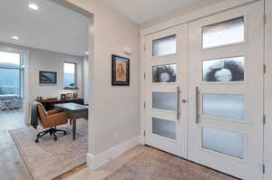 Entrance foyer with light hardwood / wood-style flooring and french doors