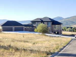 View of front of home featuring a mountain view and a garage