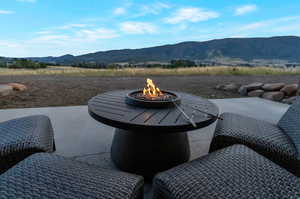 View of patio featuring a fire pit and a mountain view