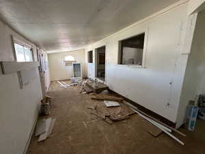 Miscellaneous room featuring lofted ceiling, a textured ceiling, and plenty of natural light