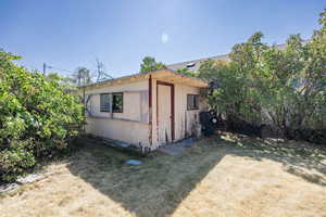 View of side of property with a lawn