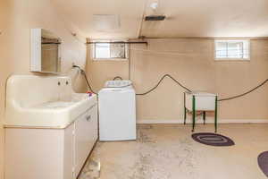 Laundry room with washer / clothes dryer and a healthy amount of sunlight