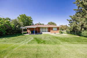 Back of house featuring a yard