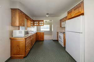 Kitchen with white appliances and sink