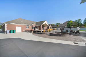 View of front of property with a fire pit and a patio area