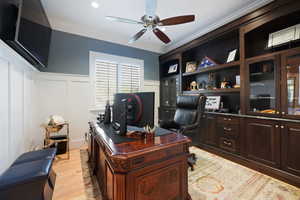 Office space featuring ceiling fan, light wood-type flooring, and ornamental molding