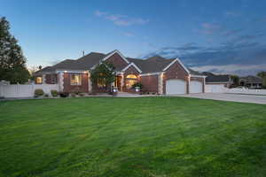 View of front of house with a garage and a yard