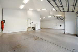 View of large 2 car garage w/epoxy flooring