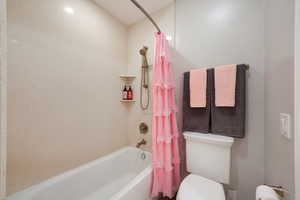 Bathroom with shower / tub combo and toilet