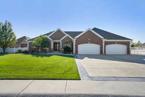 View of front facade with a garage and a front lawn