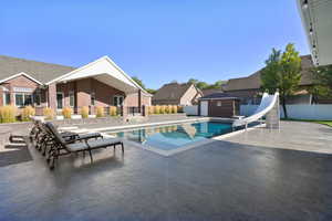 View of pool featuring a patio and a water slide