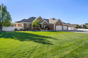 Ranch-style home with a front yard and a garage