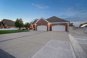 View of front facade featuring a lawn and a garage