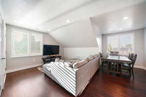 ADU - Family room featuring lofted ceiling, plenty of natural light, and dark hardwood / wood-style flooring