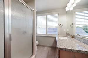 ADU - Bathroom with vanity, toilet, and an enclosed shower