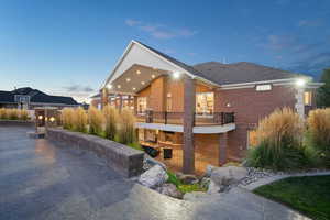 View of property exterior at dusk back patio & back deck