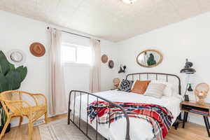 Bedroom with light hardwood / wood-style flooring