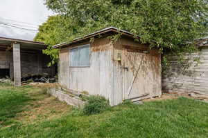 View of outbuilding with a yard