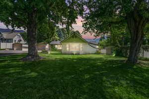 View of front of house with a lawn and a garage