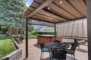 View of patio / terrace with a storage shed and a hot tub