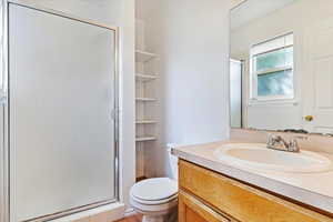 Bathroom featuring vanity, toilet, and walk in shower