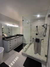 Bathroom with plus walk in shower, tile patterned flooring, and vanity