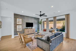 Living room featuring light hardwood / wood-style flooring and ceiling fan