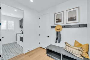 Mudroom featuring light hardwood / wood-style flooring and separate washer and dryer