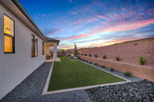 Yard at dusk with a mountain view and a patio area