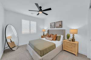 Carpeted bedroom with ceiling fan