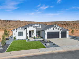 Single story home featuring a front lawn and a garage