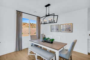 Dining space featuring an inviting chandelier and light hardwood / wood-style flooring