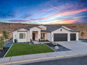 Ranch-style house with a garage and a yard