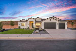 View of front of home with a lawn and a garage