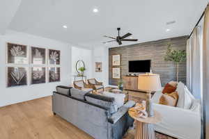 Living room with light hardwood / wood-style flooring and ceiling fan