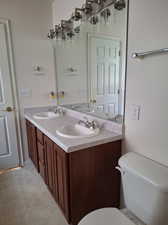 Bathroom with tile patterned flooring, vanity, and toilet