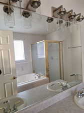 Bathroom with bath / shower combo with glass door and sink