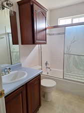 Full bathroom featuring vanity, toilet, and combined bath / shower with glass door