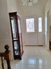 Entryway with a chandelier and light tile patterned flooring