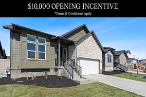 View of front of home featuring a garage and a front lawn