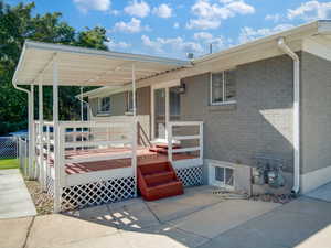 View of front of property featuring a patio and a deck