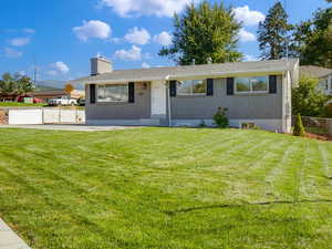 Ranch-style home with a front lawn