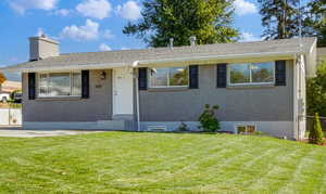 Ranch-style home with a front yard