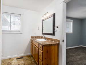 Bathroom with vanity and a textured ceiling