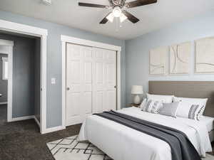 Bedroom with a textured ceiling, dark carpet, ceiling fan, and a closet